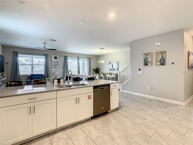 kitchen featuring dishwasher, ceiling fan with notable chandelier, sink, decorative light fixtures, and white cabinetry