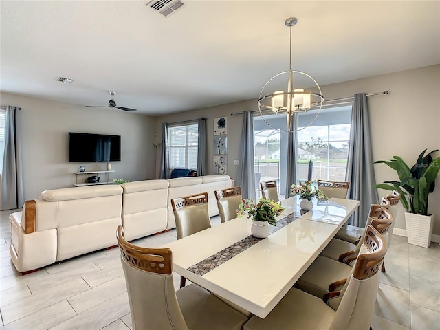 1670 Moon Valley Dr, Davenport, FL 33896 - dining space with a chandelier, light tile patterned floors, and a ceiling fan
