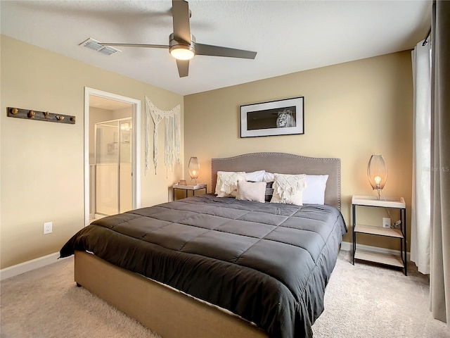 bedroom featuring light carpet, connected bathroom, and ceiling fan