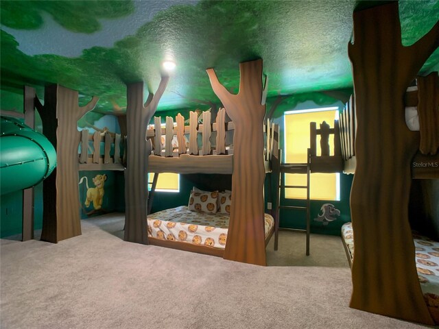 bedroom featuring carpet flooring and a textured ceiling