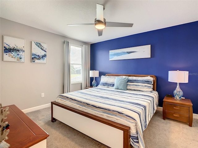 bedroom with ceiling fan and light colored carpet