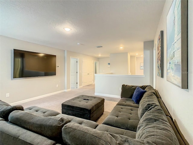 carpeted living room featuring a textured ceiling