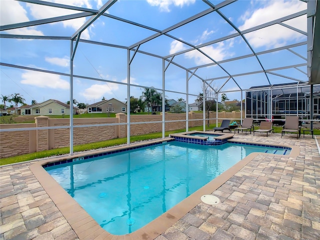 1670 Moon Valley Dr, Davenport, FL 33896 - view of swimming pool with a patio area, a pool with connected hot tub, a residential view, and glass enclosure