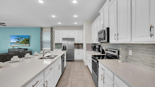 kitchen featuring white cabinetry, light tile patterned flooring, and stainless steel appliances