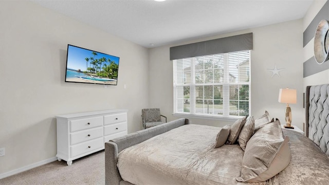 carpeted bedroom featuring multiple windows