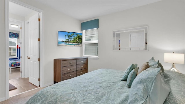 bedroom featuring light carpet