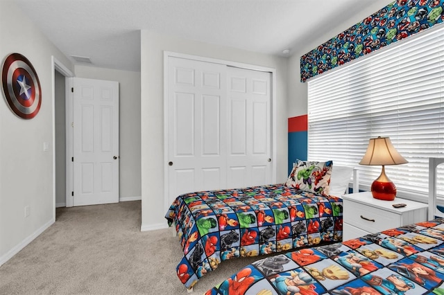 bedroom with light colored carpet and a closet