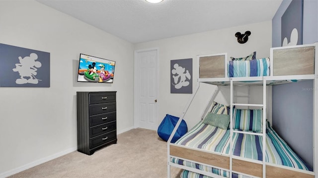 carpeted bedroom featuring a textured ceiling