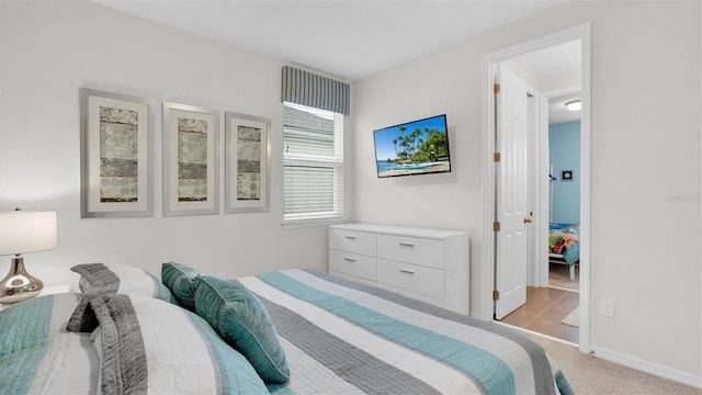 bedroom featuring light carpet