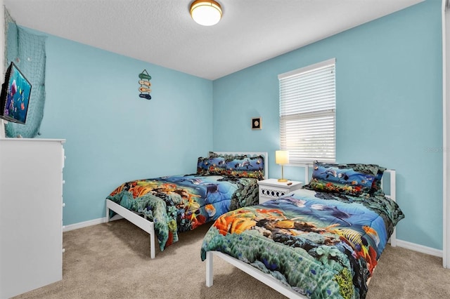 bedroom with light colored carpet and a textured ceiling