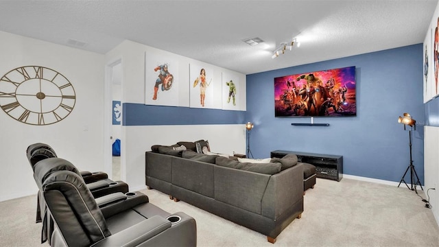 home theater with a textured ceiling and light colored carpet