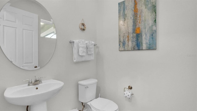 bathroom featuring toilet and sink