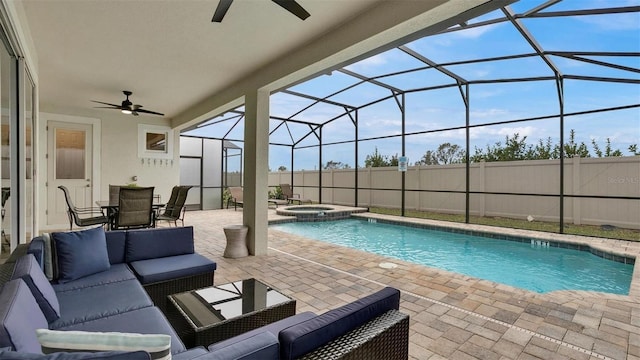 view of pool with a lanai, outdoor lounge area, an in ground hot tub, and a patio