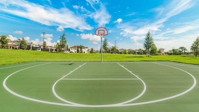 view of basketball court featuring a yard