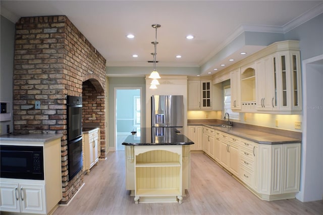 kitchen featuring a center island, hanging light fixtures, light hardwood / wood-style flooring, black appliances, and ornamental molding