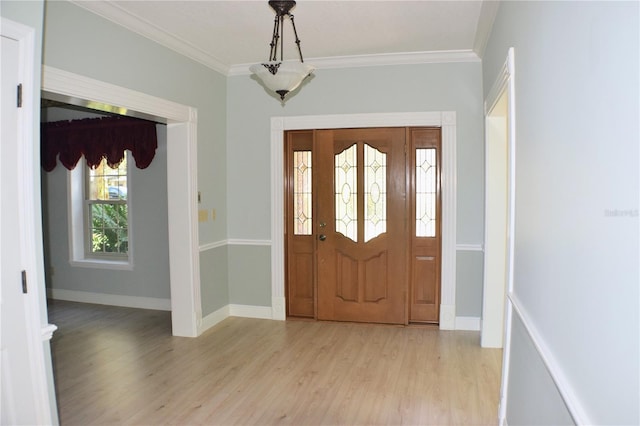 entryway with crown molding and light hardwood / wood-style floors