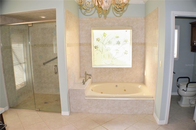 bathroom with plenty of natural light, independent shower and bath, a notable chandelier, and toilet