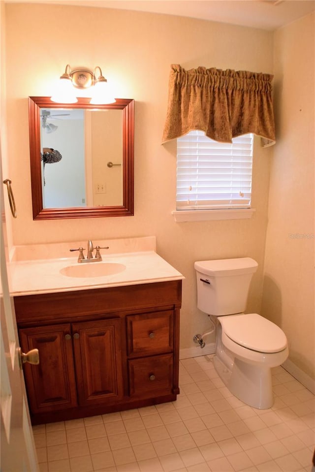 bathroom featuring tile patterned flooring, vanity, and toilet