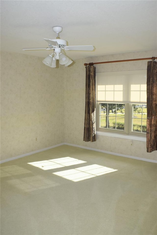 carpeted empty room with ceiling fan