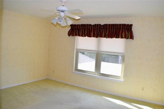 spare room featuring ceiling fan and carpet floors