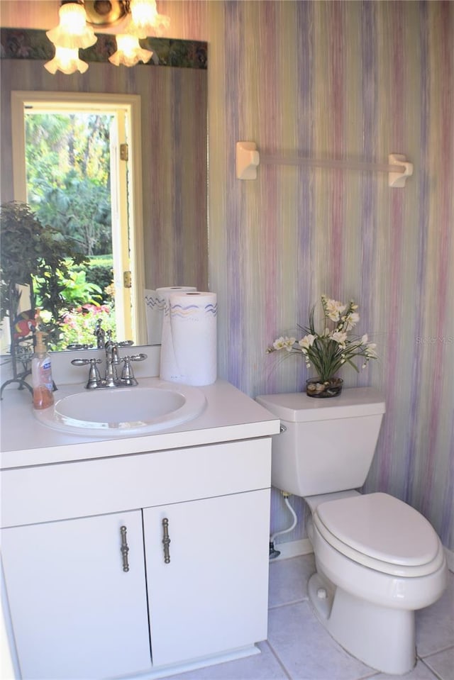 bathroom with tile patterned floors, vanity, and toilet