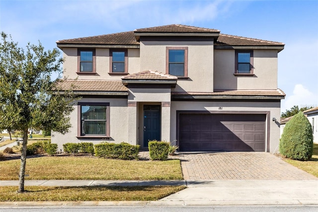 view of front of property with a garage and a front yard