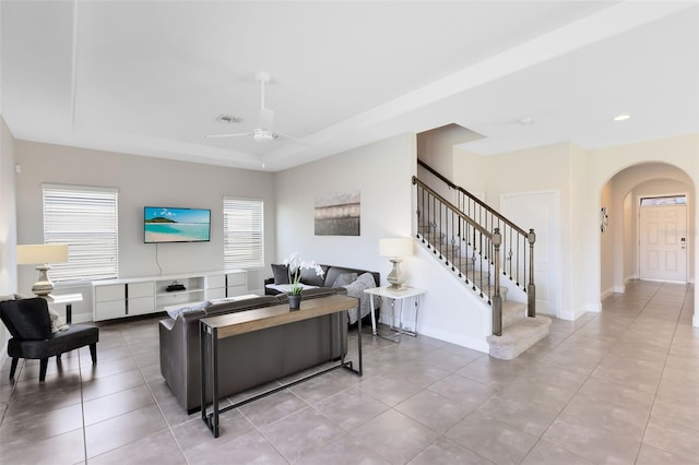 living room featuring light tile patterned floors and ceiling fan