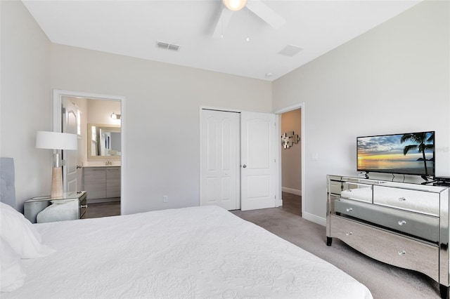 carpeted bedroom with ceiling fan, ensuite bath, and a closet