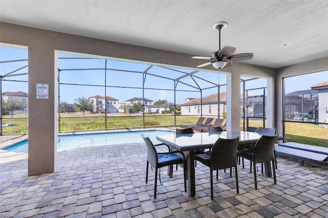 exterior space featuring ceiling fan and a lanai