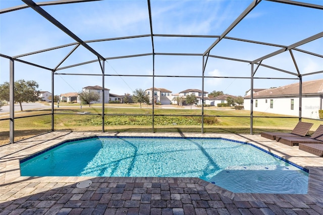 view of swimming pool with a lawn, glass enclosure, and a patio