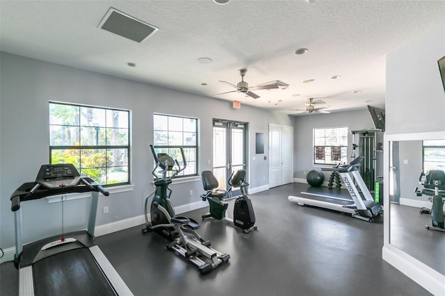 exercise room with a textured ceiling and ceiling fan