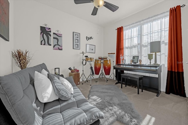 carpeted living room featuring ceiling fan