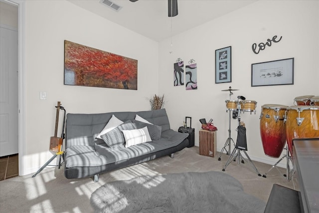 carpeted living room with ceiling fan