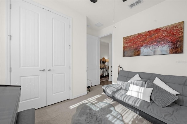 living room with ceiling fan and light carpet