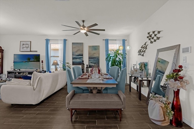 living room featuring ceiling fan, dark wood-type flooring, and a wealth of natural light