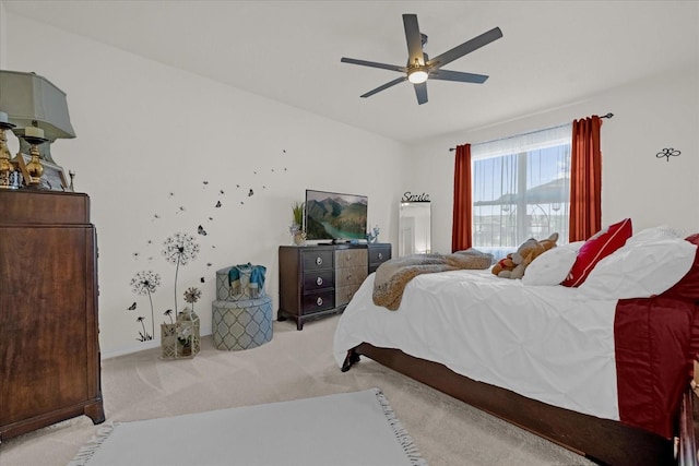 bedroom with ceiling fan and light carpet