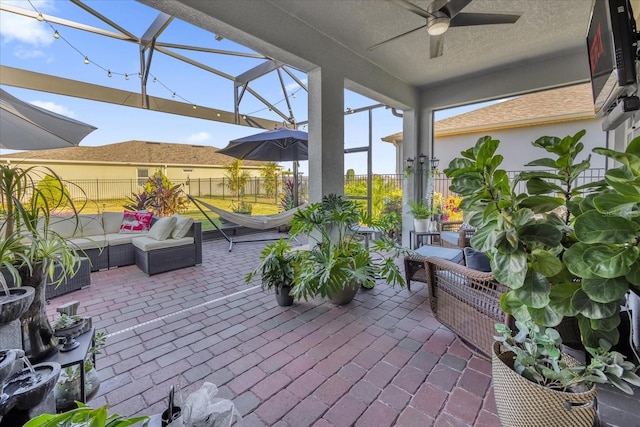 view of patio / terrace featuring an outdoor living space, ceiling fan, and a lanai