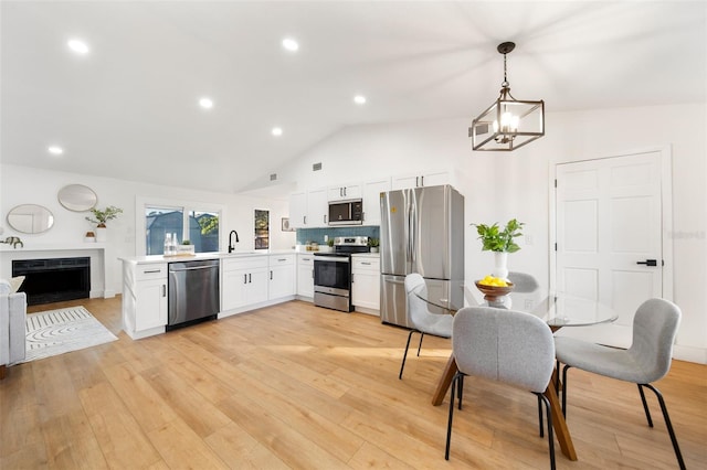 896 Talmadge Ave SE, Palm Bay, FL 32909 - kitchen with decorative light fixtures, stainless steel appliances, light hardwood / wood-style flooring, and sink
