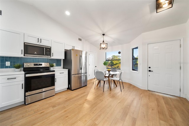 896 Talmadge Ave SE, Palm Bay, FL 32909 - kitchen with white cabinets, appliances with stainless steel finishes, and pendant lighting