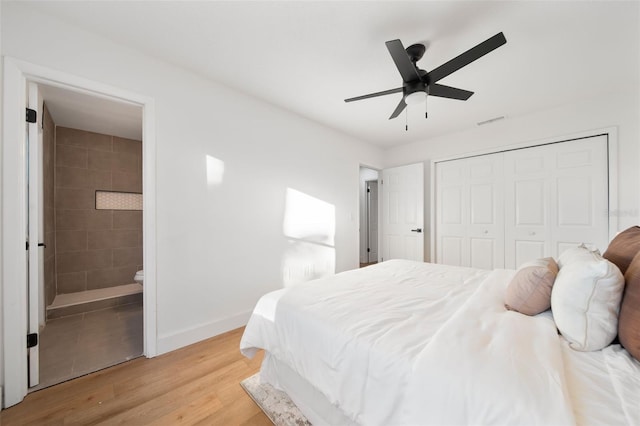 896 Talmadge Ave SE, Palm Bay, FL 32909 - bedroom featuring connected bathroom, ceiling fan, a closet, and light wood-type flooring