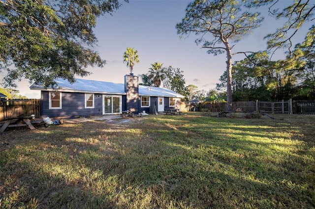 896 Talmadge Ave SE, Palm Bay, FL 32909 - back house at dusk featuring a yard