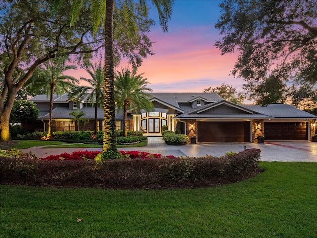 view of front of house featuring a garage and a yard