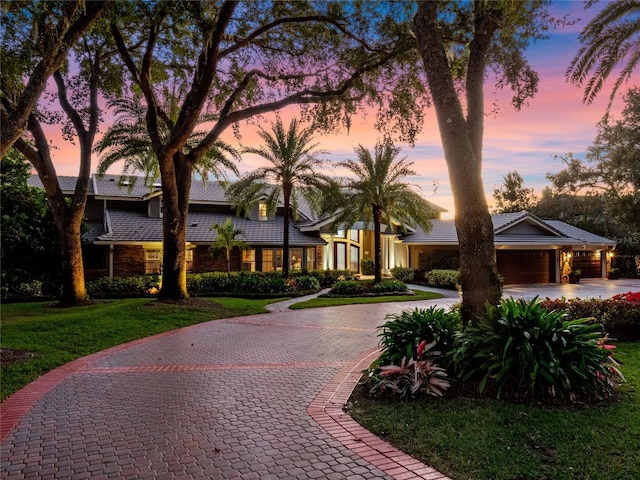 view of front of property with a lawn and a garage