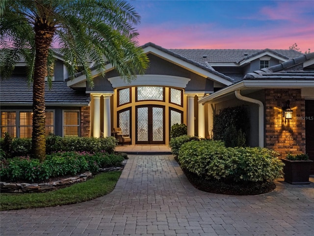 exterior entry at dusk with french doors