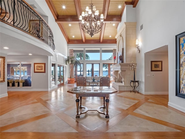 entrance foyer featuring wooden ceiling, a high ceiling, french doors, crown molding, and light hardwood / wood-style flooring