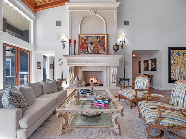 living room with french doors, a high end fireplace, and high vaulted ceiling