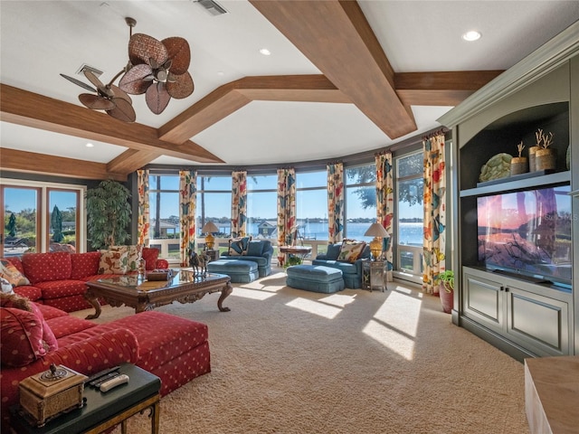 living room with carpet, ceiling fan, and beamed ceiling