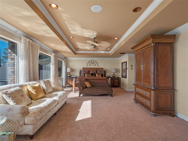 bedroom featuring ceiling fan, a raised ceiling, light colored carpet, and crown molding