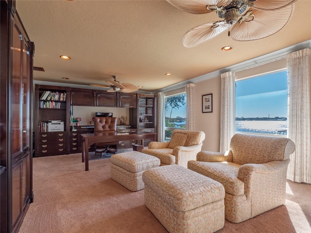 living room with light carpet, a textured ceiling, a water view, and ornamental molding