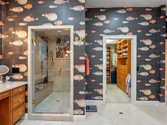 bathroom with tile patterned flooring, vanity, and a shower with shower door